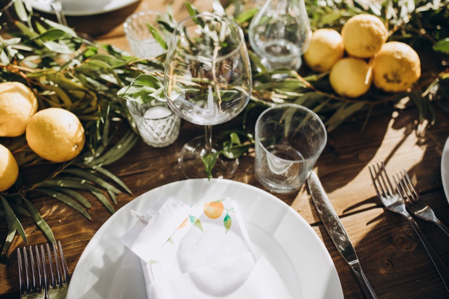 Table set with lemons and olive branches for a private dinner in Italy